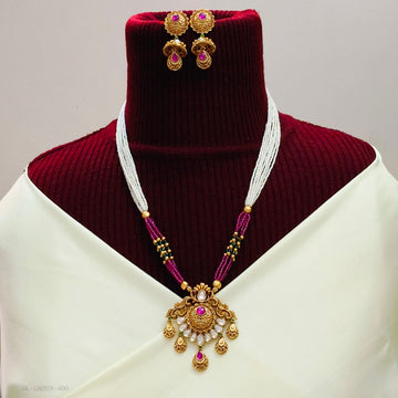 Antique gold necklace with a beaded chain and a stone-studded pendant
