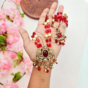 Kundan and pearl beaded necklace set with red stone accent