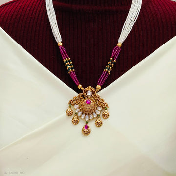Antique gold necklace with a beaded chain and a stone-studded pendant