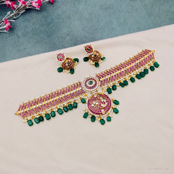 Kemp temple choker necklace set with green beads
South Indian kemp choker jewellery set
Ruby kemp temple choker with earrings
Traditional bridal temple choker necklace
Pink kemp choker necklace imitation jewellery
