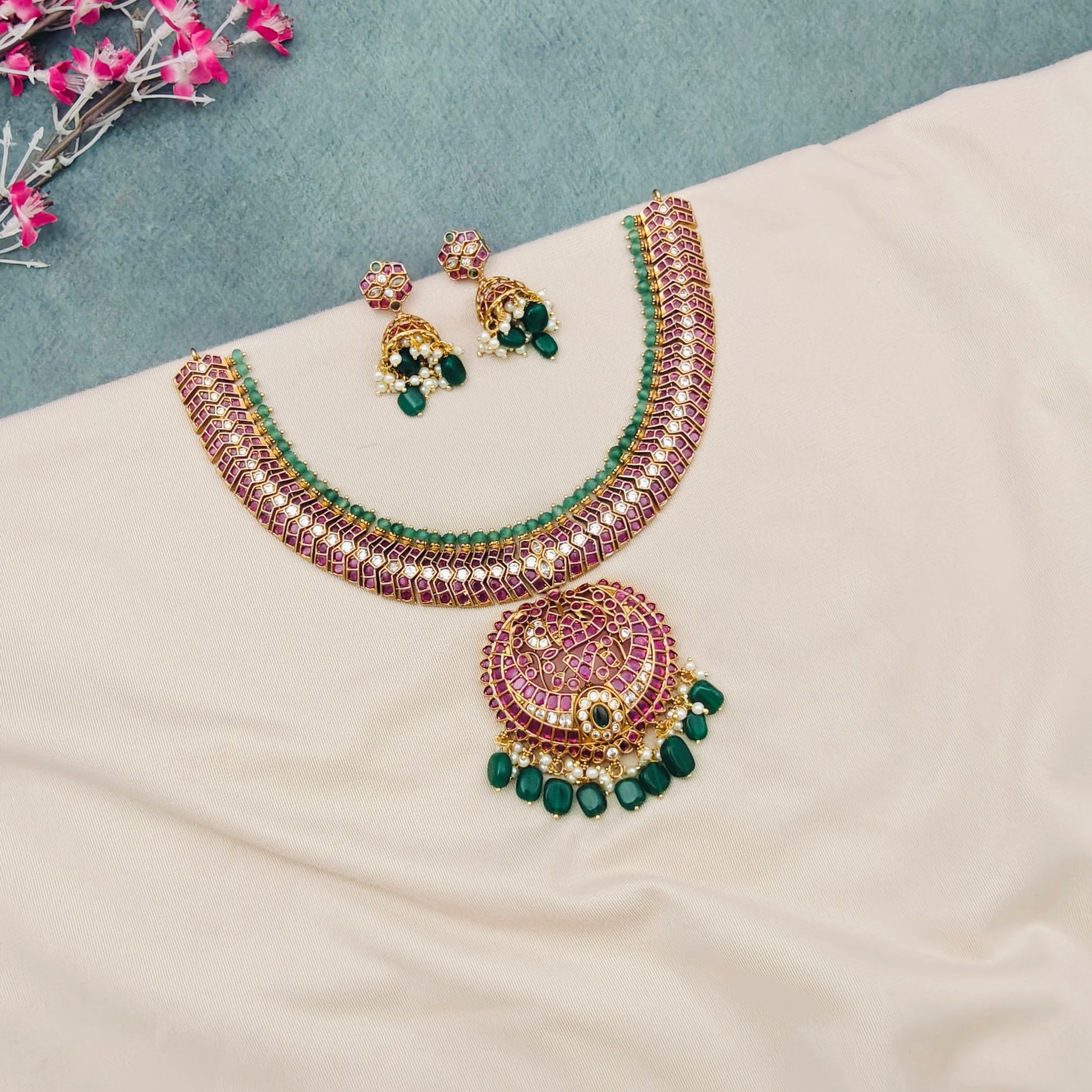 Lakshmi kemp temple choker necklace set
South Indian temple choker jewellery set
Ruby kemp Lakshmi pendant choker necklace
Traditional bridal temple choker set
Temple jewellery choker with green beads
