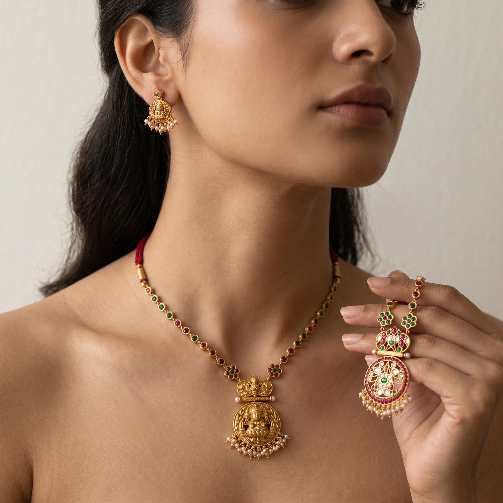 Model wearing delicate reversible temple jewellery set against a neutral background, emphasizing micro-texture and realistic gold tone.
